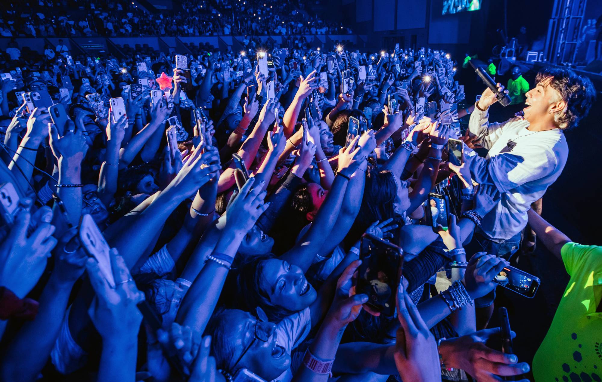 A member of Latin Mafia band performs with the crowd during a concert at Auditorio Citibanamex on September 10, 2023 in Monterrey, Mexico. (Photo by Medios y Media/Getty Images)