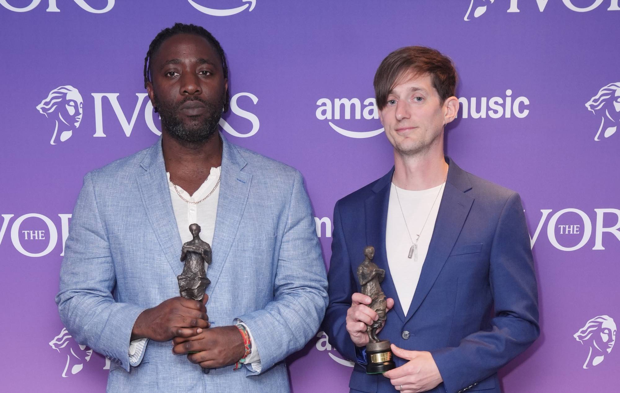 Kele Okereke and Russell Lissack from Bloc Party with their Outstanding Contribution awards pose in the winners